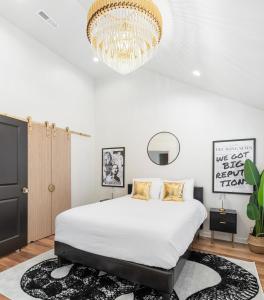 a bedroom with a large bed and a chandelier at Taylor Swift Eras Inspired Home-10 min to Broadway in Nashville