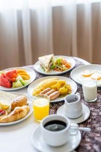 a table with plates of food and a cup of coffee at Kailash Boutique Hotel in Kathmandu