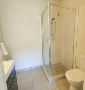 a bathroom with a shower and a toilet at Mount Stunner with King Beds in Mount Maunganui