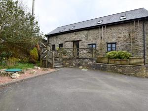 a stone building with a driveway in front of it at 2 Bed in Exmoor 83062 in Challacombe