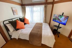 1 dormitorio con 1 cama y TV en On JR Line, Direct to Ikebukuro, Shinjuku/Shibuya 01, en Tokio