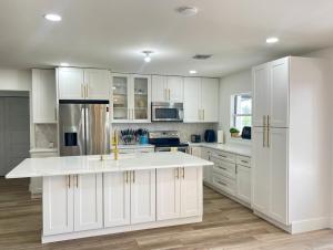 a kitchen with white cabinets and a white counter top at Gorgeous waterfront home on the St. Johns River in Osteen