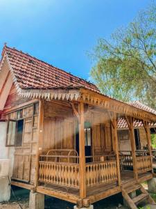 a large wooden house with a porch at Mimpi Bungalow in Gili Meno