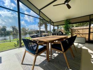 a wooden table and chairs on a patio at Gorgeous waterfront home on the St. Johns River in Osteen