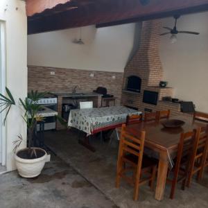 a living room with a wooden table and chairs at Edicula Paz e Amor in Piracicaba