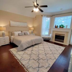 a bedroom with a white bed and a fireplace at Convenient location in upscale city of Southlake. in Southlake +21 photos