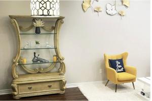 a yellow chair and a shelf in a room at Luxury Room in Mississauga