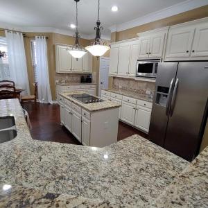 a kitchen with white cabinets and a stainless steel refrigerator at Convenient location in upscale city of Southlake. in Southlake