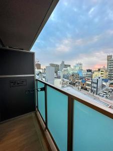 a balcony with a view of a city at Hoshino Stay 1 in Osaka