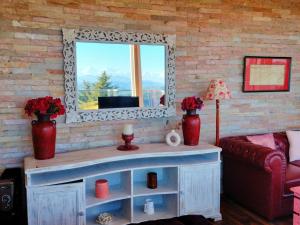 a living room with a mirror and a couch at Fairmont cottage Mukteshwar in Mukteshwar