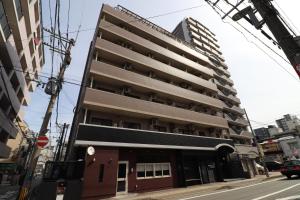 a building on the corner of a street at Forest Inn Fukuoka -previously Pure Tenjin- in Fukuoka