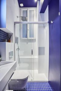 a bathroom with a glass shower and a toilet at Designer luxury flat in Central Paris - 2bed 2bath with AC in Paris
