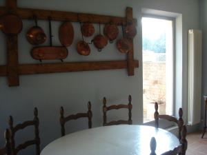 a dining room with a table and plates on the wall at La Vigna Apartment in Siena