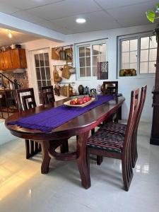 a wooden table with a bowl of fruit on it at Casa Geranios Antigua in Antigua Guatemala