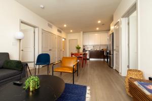 a living room with a couch and a table at Modern Nulu 2BR CozySuites 05 in Louisville
