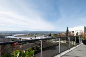 a balcony with a view of a river at Riverview Escape in Inveresk