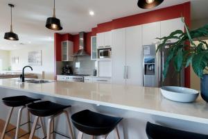 a kitchen with a large counter with stools at Riverview Escape in Inveresk