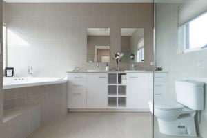 a white bathroom with a sink and a toilet at Riverview Escape in Inveresk +30 photos