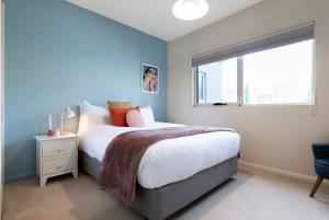 a bedroom with a large bed and a window at Riverview Escape in Inveresk
