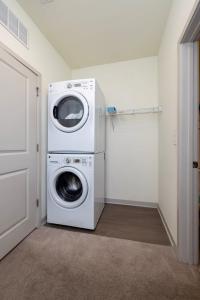 a washer and dryer in a laundry room at Stunning Nulu 1BR CozySuites 06 in Louisville