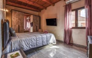 a bedroom with a bed and a large window at Beautiful Home In Acireale With Wifi in Acireale