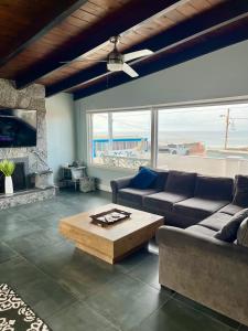 a living room with a couch and a coffee table at Rosarito Beach House Sleeps 14 & Steps to Sandy Beach Mins to Downtown in Rosarito