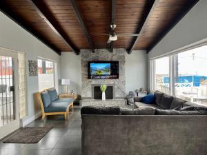 a living room with a couch and a fireplace at Rosarito Beach House-- Spacious, Central, Beach View, & Sleeps 14 in Rosarito