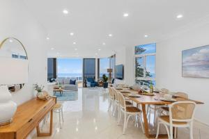 a dining room with a table and chairs at Ocean Vista Escape - A Lofty Beachfront Penthouse in Wollongong