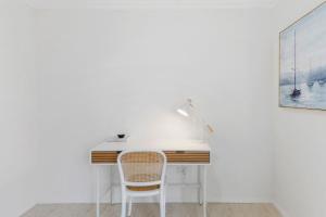 an office with a desk and a chair at Ocean Vista Escape - A Lofty Beachfront Penthouse in Wollongong