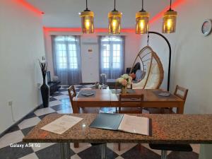- une salle à manger avec une table, des chaises et des lumières dans l'établissement Apartment in Biscoitos Terceira, à Biscoitos