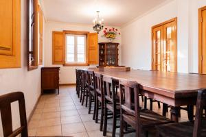 a large dining room with a large wooden table and chairs at Casa Amarela, 9-room beach house in Praia da Barra