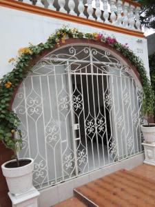 an ornate gate with flowers on top of it at Pequeño y acojedor departamento muy bien ubicado in Veracruz