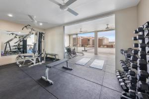 a gym with treadmills and elliptical machines at The Terraces Boutique Apartments in Port Vila