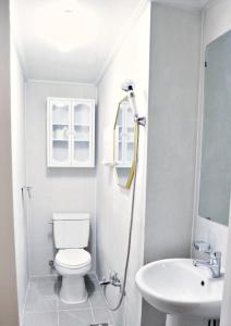 a white bathroom with a toilet and a sink at 3rooms 4beds kitchen Hongik Stn 3min in Seoul