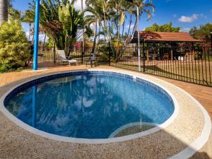 a swimming pool in a yard with a fence at BIG4 Townsville Gateway Holiday Park in Townsville
