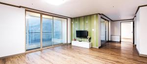 a large room with a television and large windows at Milmo Resort Family Hotel in Muju