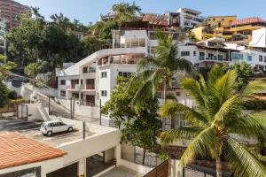 a white car parked in front of a building at BEST Views of PV-Banderas Bay from Rooftop Infinity Pool in Puerto Vallarta