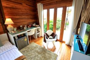 a bedroom with a bed and a desk in a room at Viangviman Luxury Resort, Krabi in Ao Nang Beach