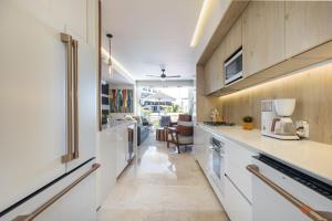 a kitchen with white cabinets and a counter top at BEST Views of PV-Banderas Bay from Rooftop Infinity Pool in Puerto Vallarta