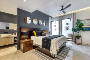 a bedroom with a bed and a sink and mirrors at BEST Views of PV-Banderas Bay from Rooftop Infinity Pool in Puerto Vallarta +46 photos