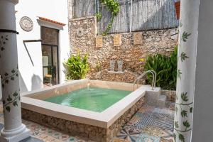 a bath tub in front of a stone building at Casa Iktal Luxury - Centro Mérida in Mérida