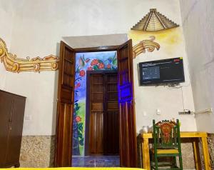 a door to a room with a painting on the wall at Casa Iktal Luxury - Centro Mérida in Mérida