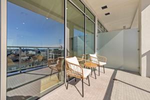 a balcony with a table and chairs on a building at @ Marbella Lane - Modern 1BR Gem in Long Beach in Long Beach