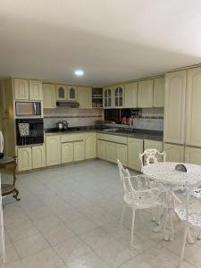 a kitchen with a table and a table and chairs at Valle Suites Boutique in Valledupar