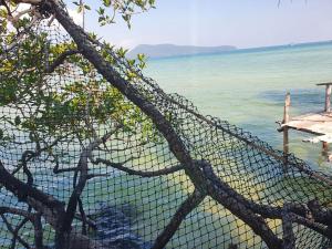 a mesh fence with a view of the ocean at Mangrove Beach Bungalows in Koh Rong Sanloem