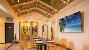 a dining room with a table and chairs and the ocean at Casa Condado Residences & Hotel Rooms in San Juan