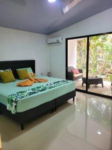 a bedroom with a large bed in a room at Luba house in Puerto Jiménez