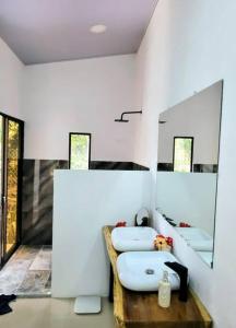 a bathroom with two sinks and a mirror at Luba house in Puerto Jiménez