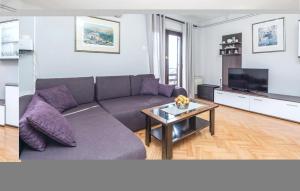 a living room with a couch and a table at Cozy Apartment In Rukavac With Outdoor Swimming Pool in Rukavac