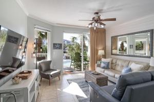 a living room with a couch and a tv at Gulfside 210 - 2BR plus bunkroom with Ocean & Pool Views in Fort Walton Beach